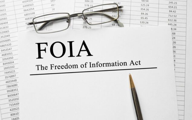 Paper with The Freedom of Information Act (FOIA) on a table